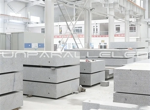 news-1-1 Black granite bases and components stacked in the UNPARALLELED workshop ready for grinding and inspection